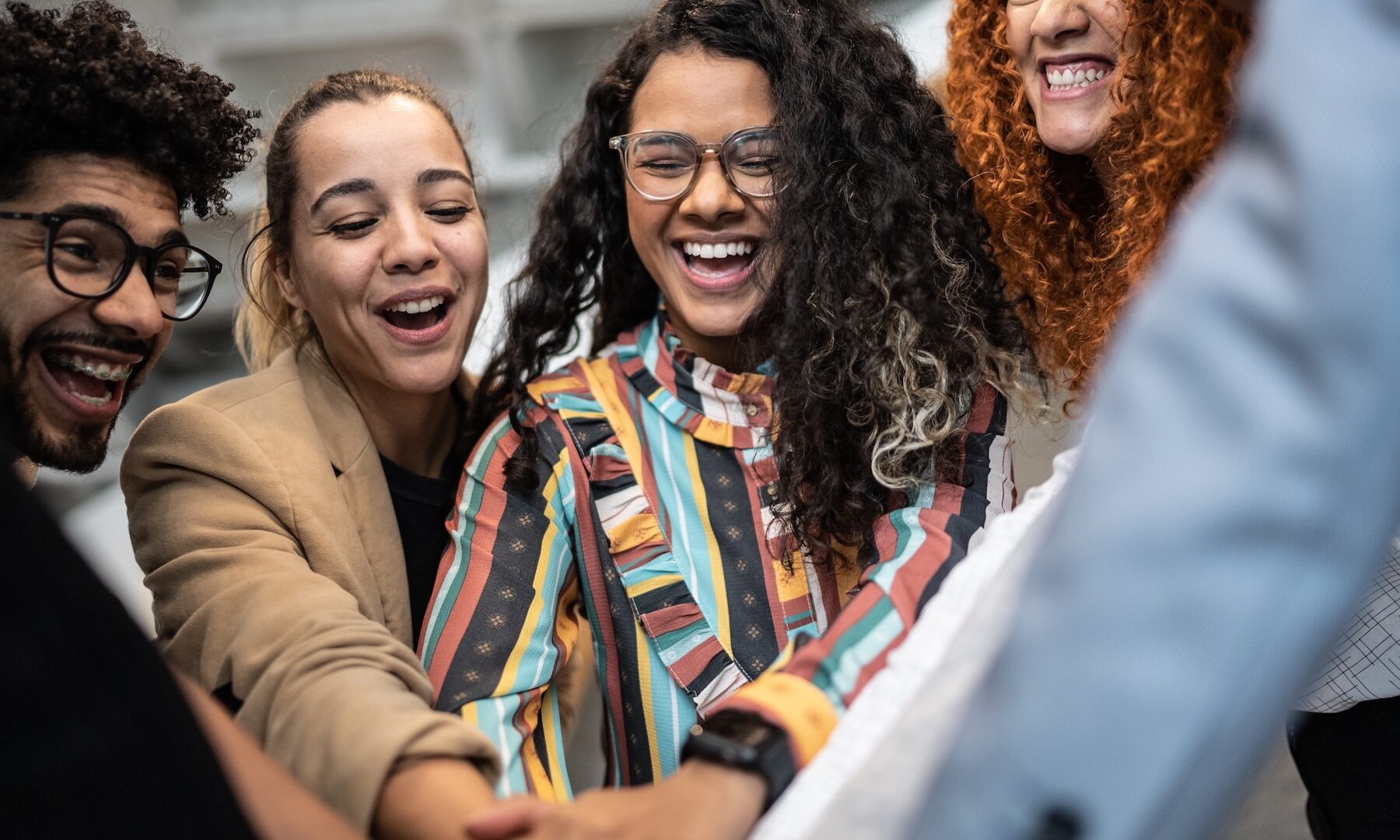 Coworkers with stacked hands at the office